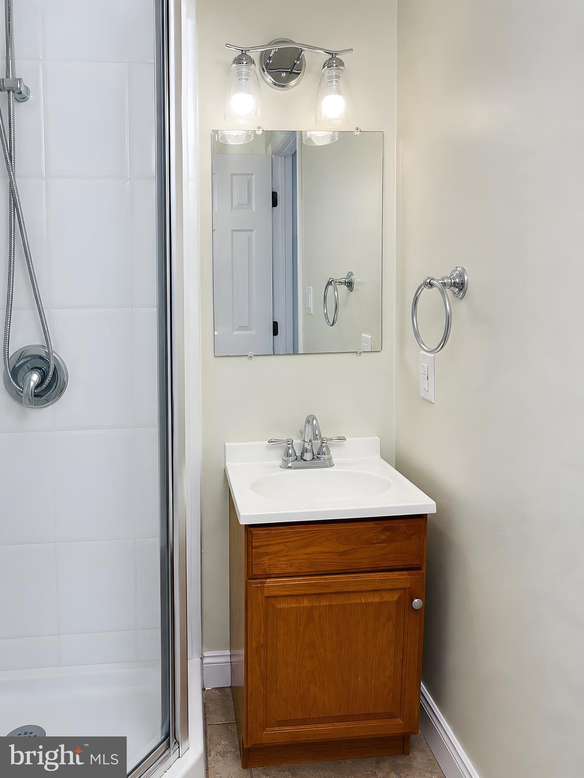 17248 Gum Landing Road St. Inigoes, MD 20684 - Photo 32 of 56 a bathroom with a sink vanity and mirror
