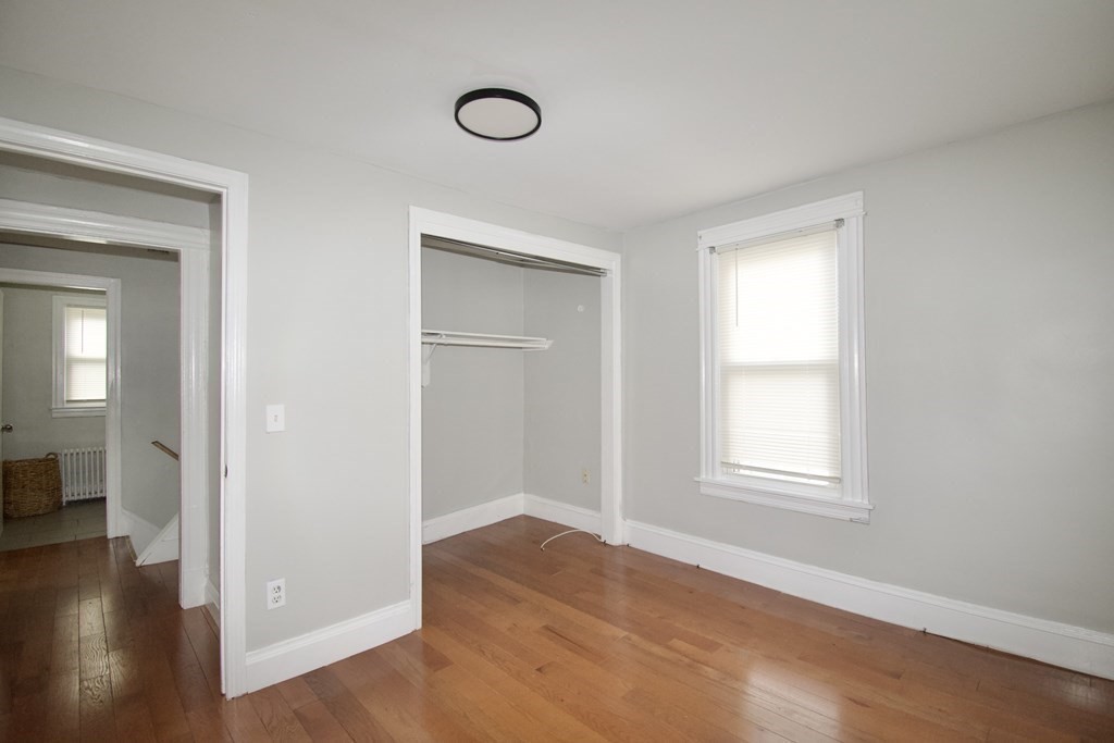 19 Agnes Street Springfield, MA 01118 - Photo 17 of 34 an empty room with wooden floor and windows