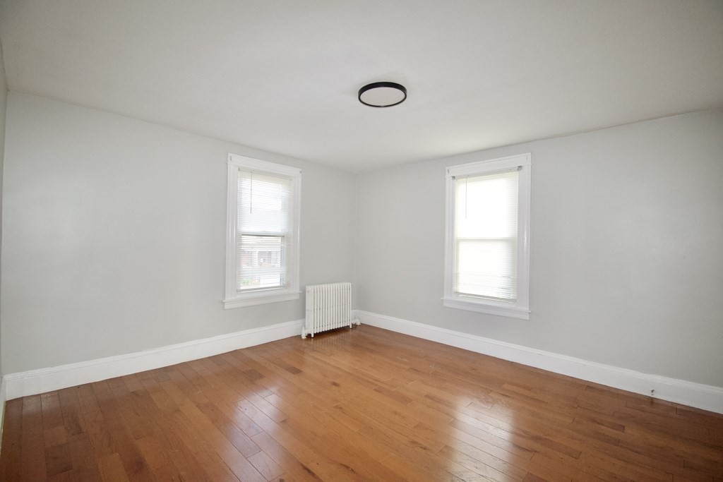 19 Agnes Street Springfield, MA 01118 - Photo 18 of 34 an empty room with wooden floor and windows