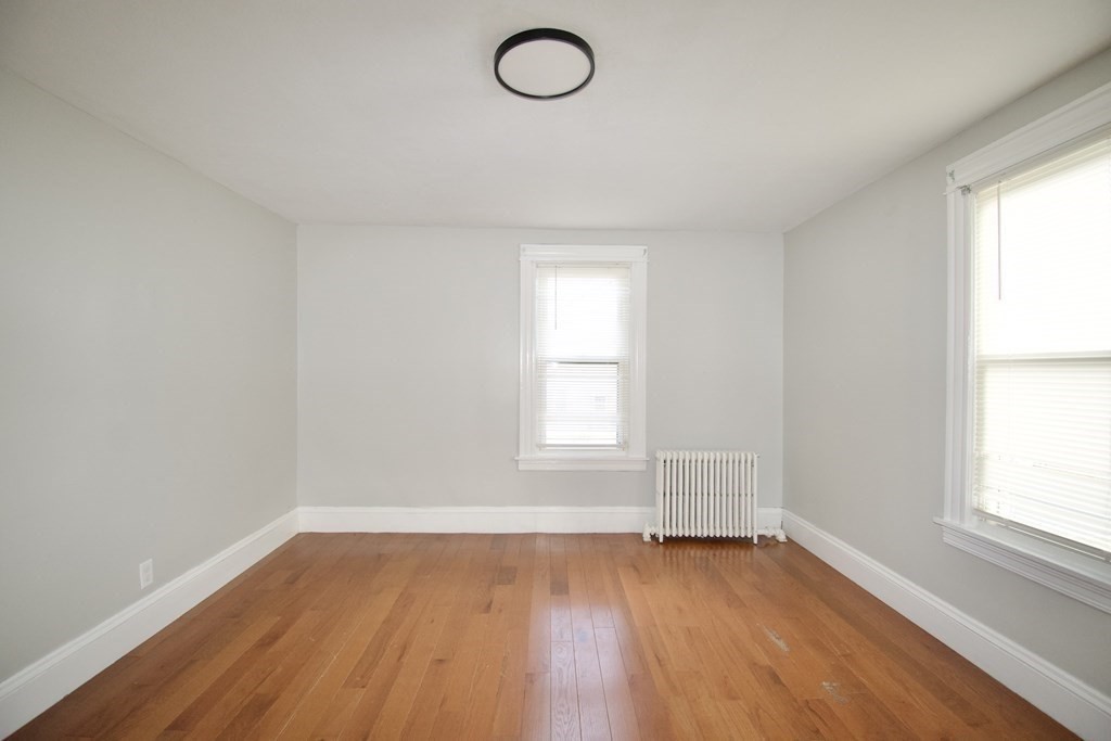 19 Agnes Street Springfield, MA 01118 - Photo 23 of 34 an empty room with wooden floor and windows