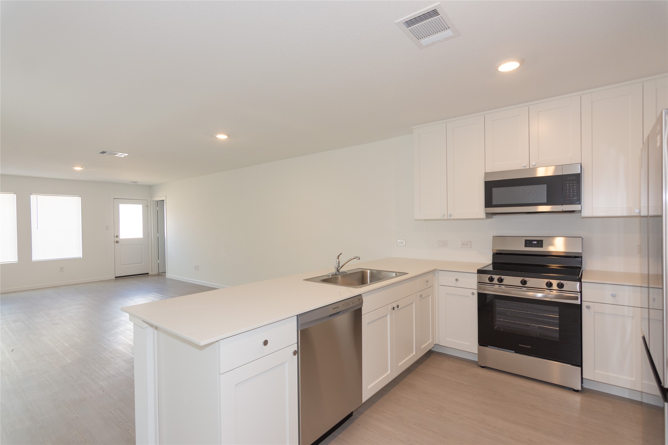 149 Star Packer Lane Jarrell, TX 76537 - Photo 10 of 30 A well-equipped kitchen boasts bright white cabinetry and stainless steel appliances.