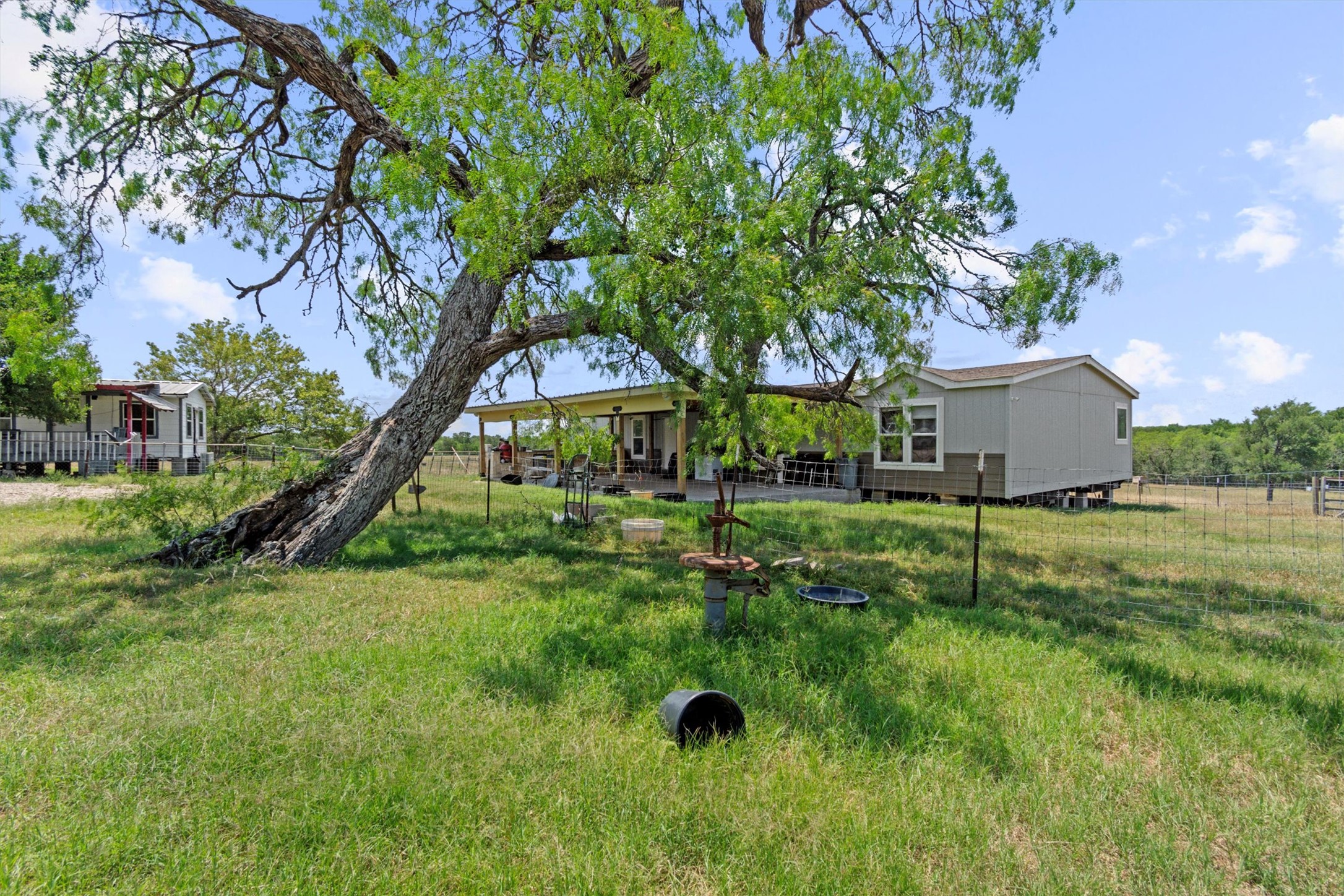 480 Grandpa Road Lockhart, TX 78644 - Photo 3 of 35 The centerpiece is a spacious ~2,061 sq ft manufactured home, just 1.5
years old, with 4 bedrooms, 2 bathrooms, and a beautifully crafted 40' x 20' stone outdoor kitchen under a covered
roof with lighting—ideal for hosting under the stars.