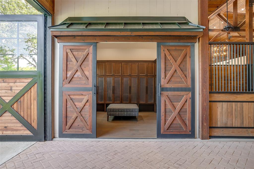 5000 T W King Road Southlake, TX 76092 - Photo 12 of 40 Custom jockey-style locker room with built-in cabinetry, boot storage, and vanity — blending function and elegance.