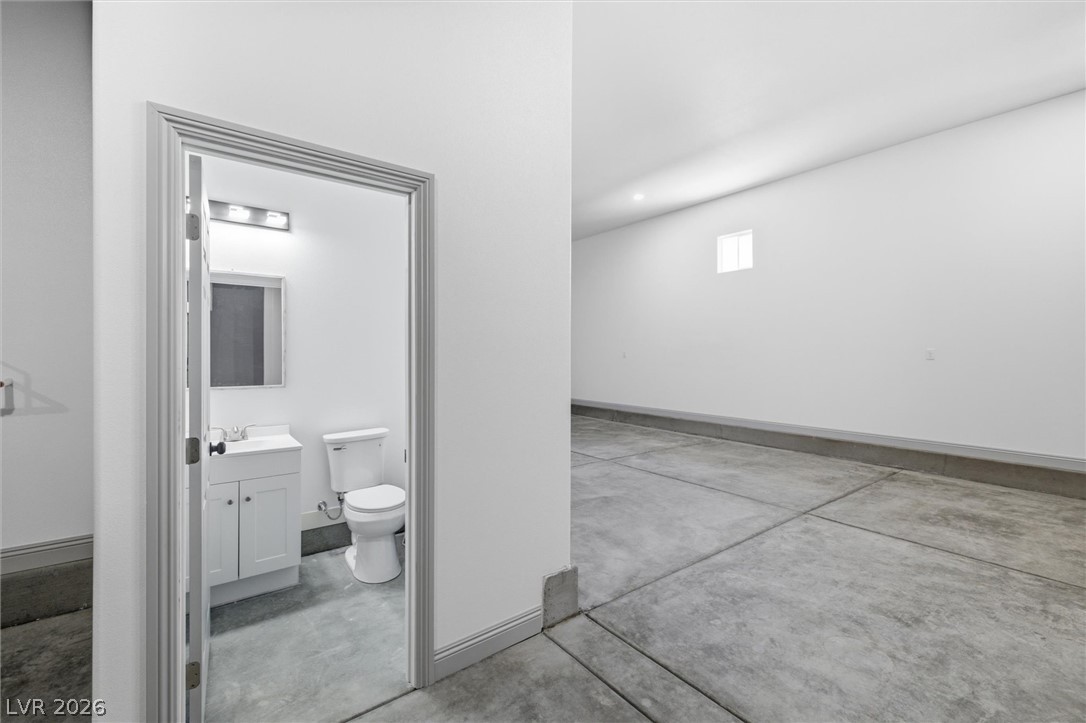 1061 Factory Road Pahrump, NV 89048 - Photo 31 of 41 A well-maintained garage features a convenient half bath, perfect for projects and daily use.