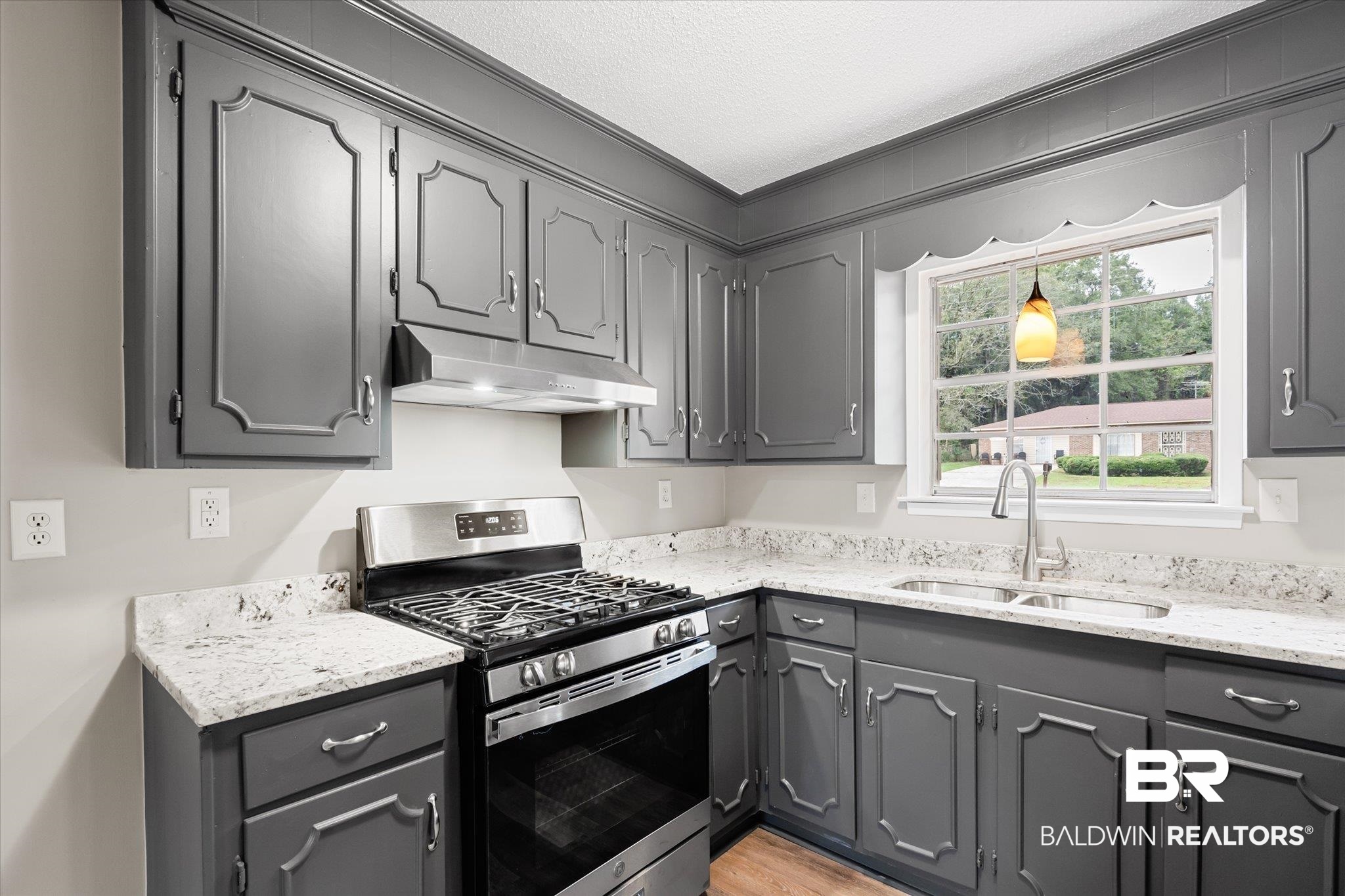 5015 Golfway Drive Eight Mile, AL 36613 - Photo 6 of 31 Kitchen featuring light stone countertops, gas range, a textured ceiling, sink, and gray cabinets
