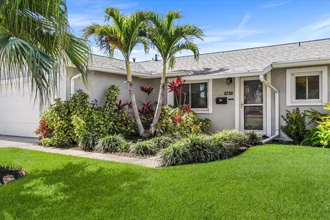 a front view of house with yard and trees