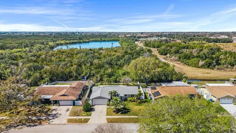 an aerial view of a house with a lake view