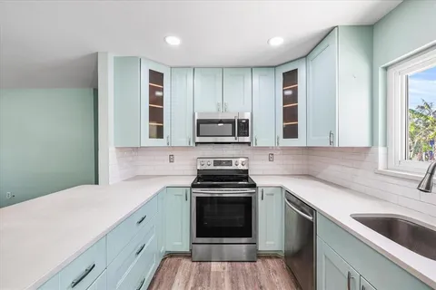 a kitchen with a sink stove and microwave