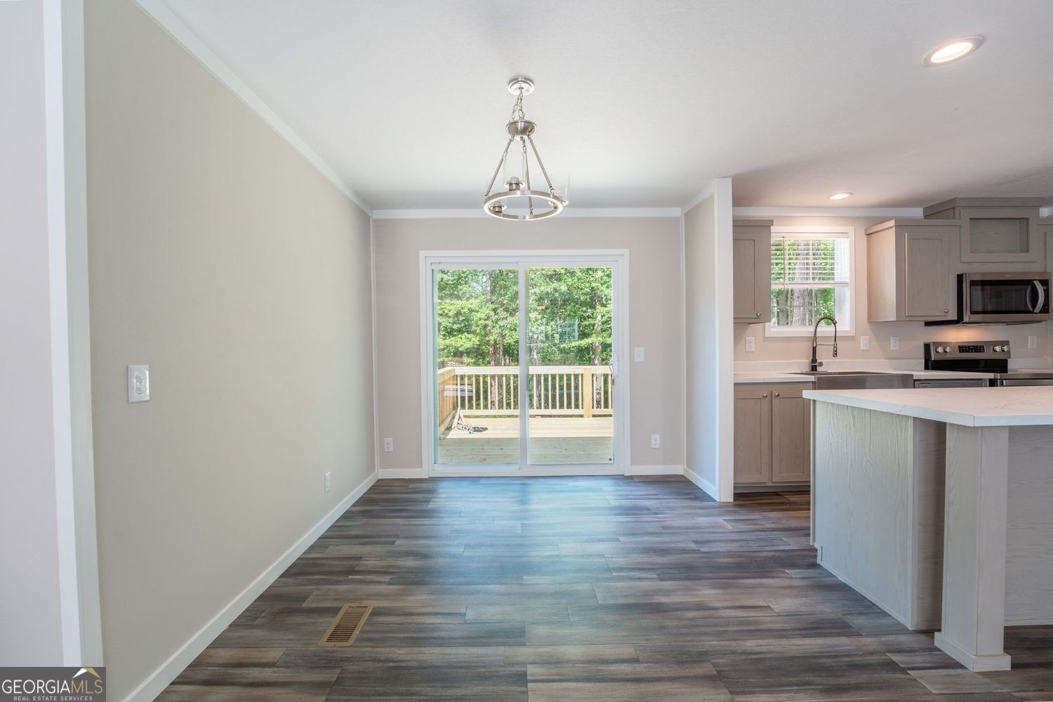 734 Hollywood Church Road Clarkesville, GA 30523 - Photo 12 of 49 a view of a kitchen with a sink and dishwasher with wooden floor