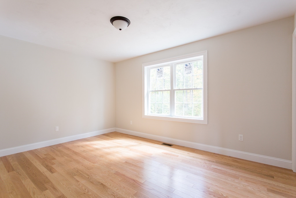 8 Foster Road West Brookfield, MA 01585 - Photo 11 of 29 an empty room with wooden floor and windows