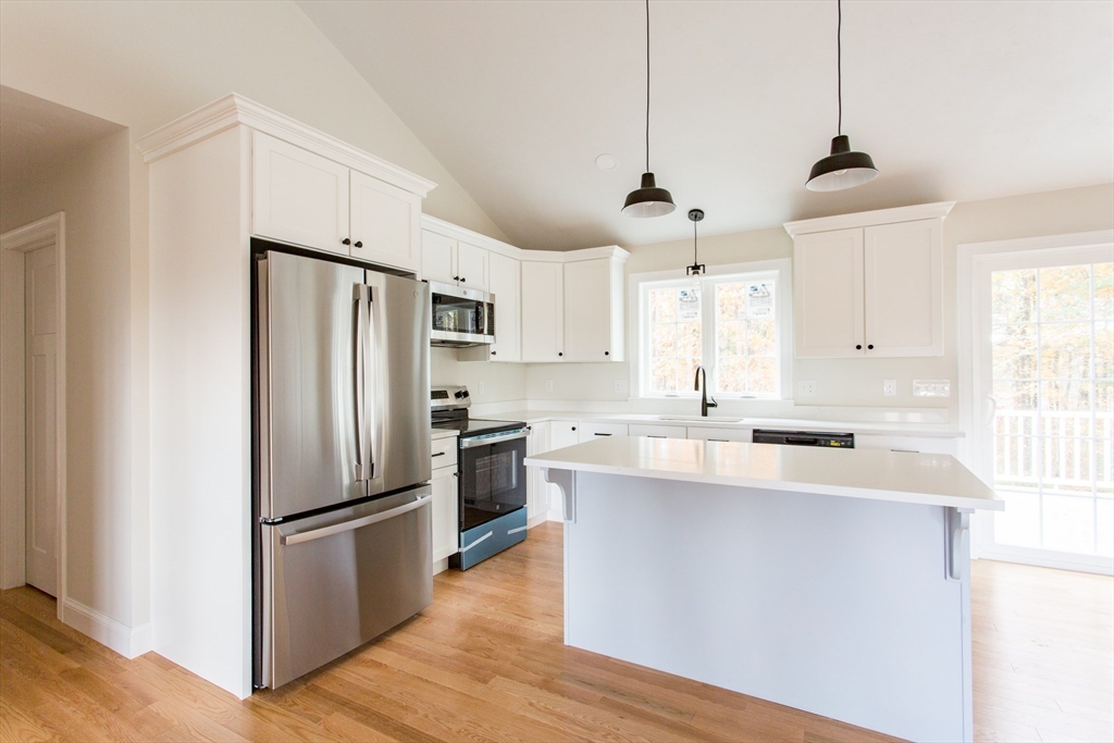 8 Foster Road West Brookfield, MA 01585 - Photo 7 of 29 a kitchen with stainless steel appliances a refrigerator sink and wooden floor