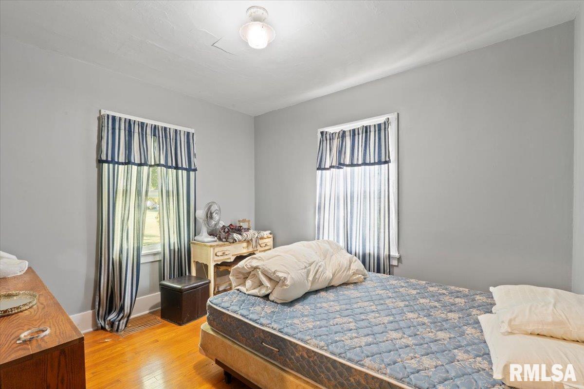 3302 38th Avenue Moline, IL 61265 - Photo 24 of 29 a bedroom with a bed and wooden floor