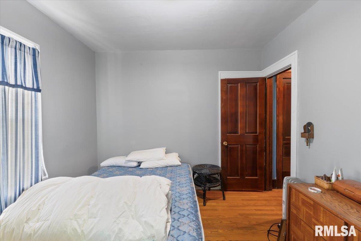 3302 38th Avenue Moline, IL 61265 - Photo 25 of 29 a bedroom with a bed and wooden floor