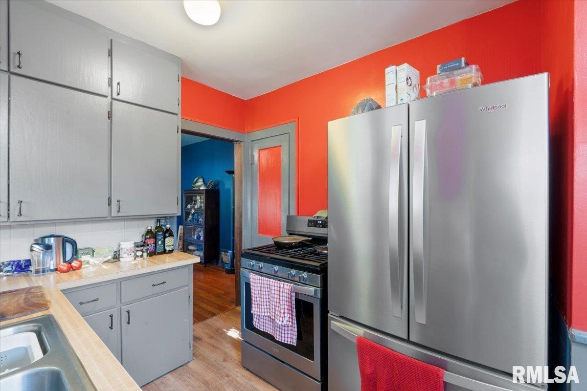 3302 38th Avenue Moline, IL 61265 - Photo 27 of 29 a kitchen with stainless steel appliances granite countertop a refrigerator and a stove top oven