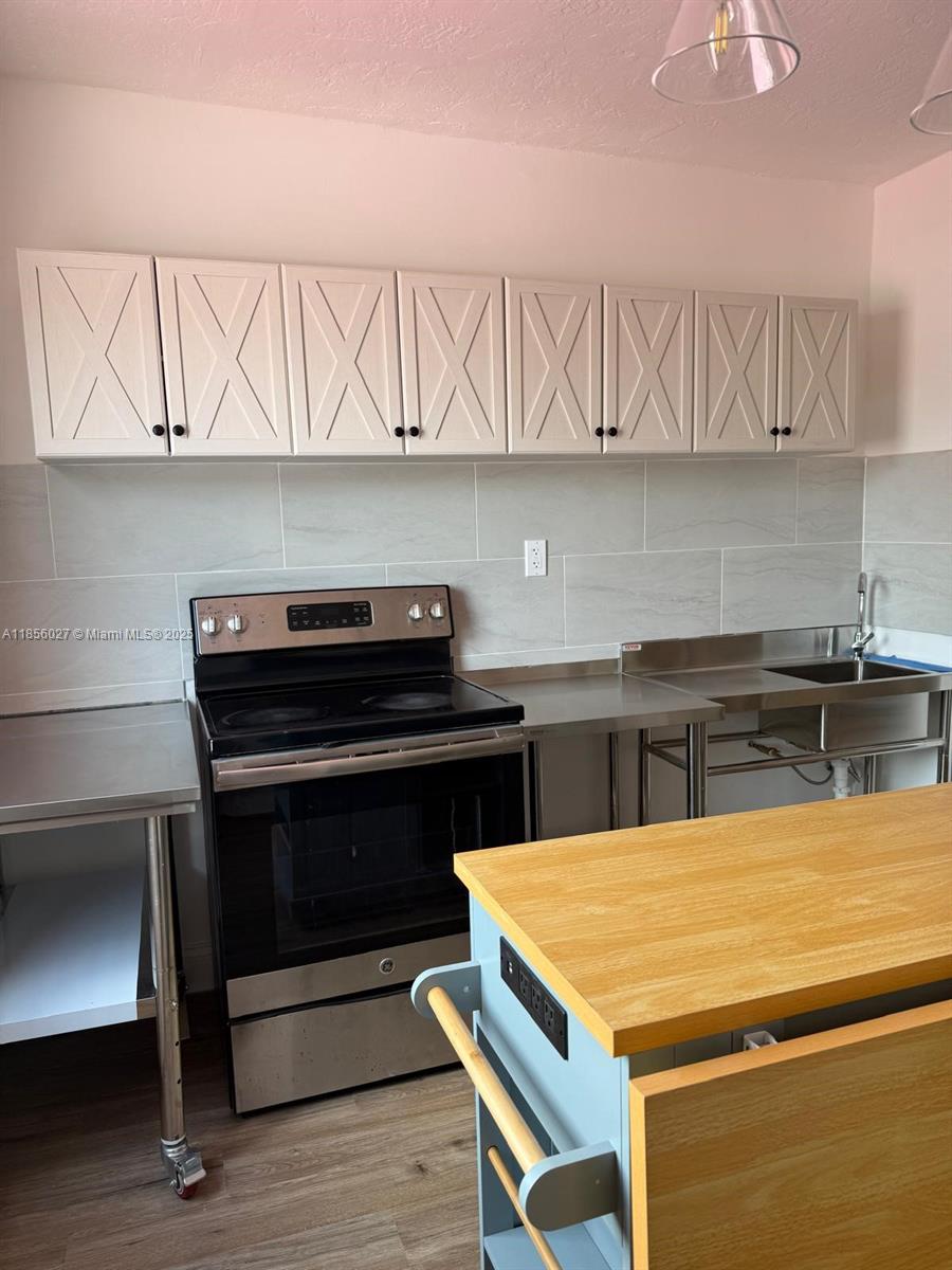 a kitchen with a table chairs and cabinets