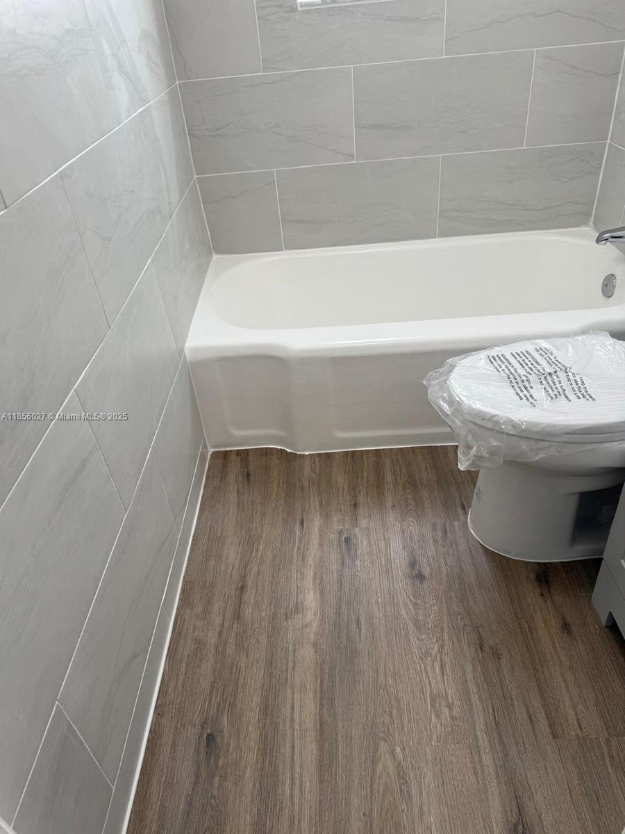 1432 Northeast 163rd Street, Unit 2 North Miami Beach, FL 33162 - Photo 13 of 18 a bathroom with a bathtub and a shower