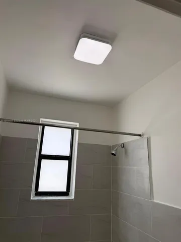 a bathroom with a sink and a window