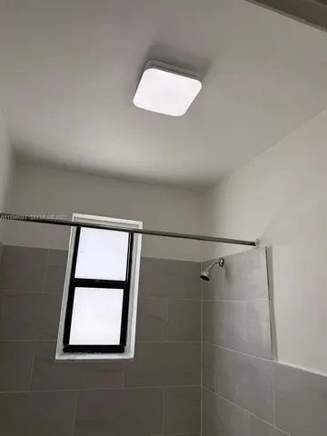 a bathroom with a sink and a window