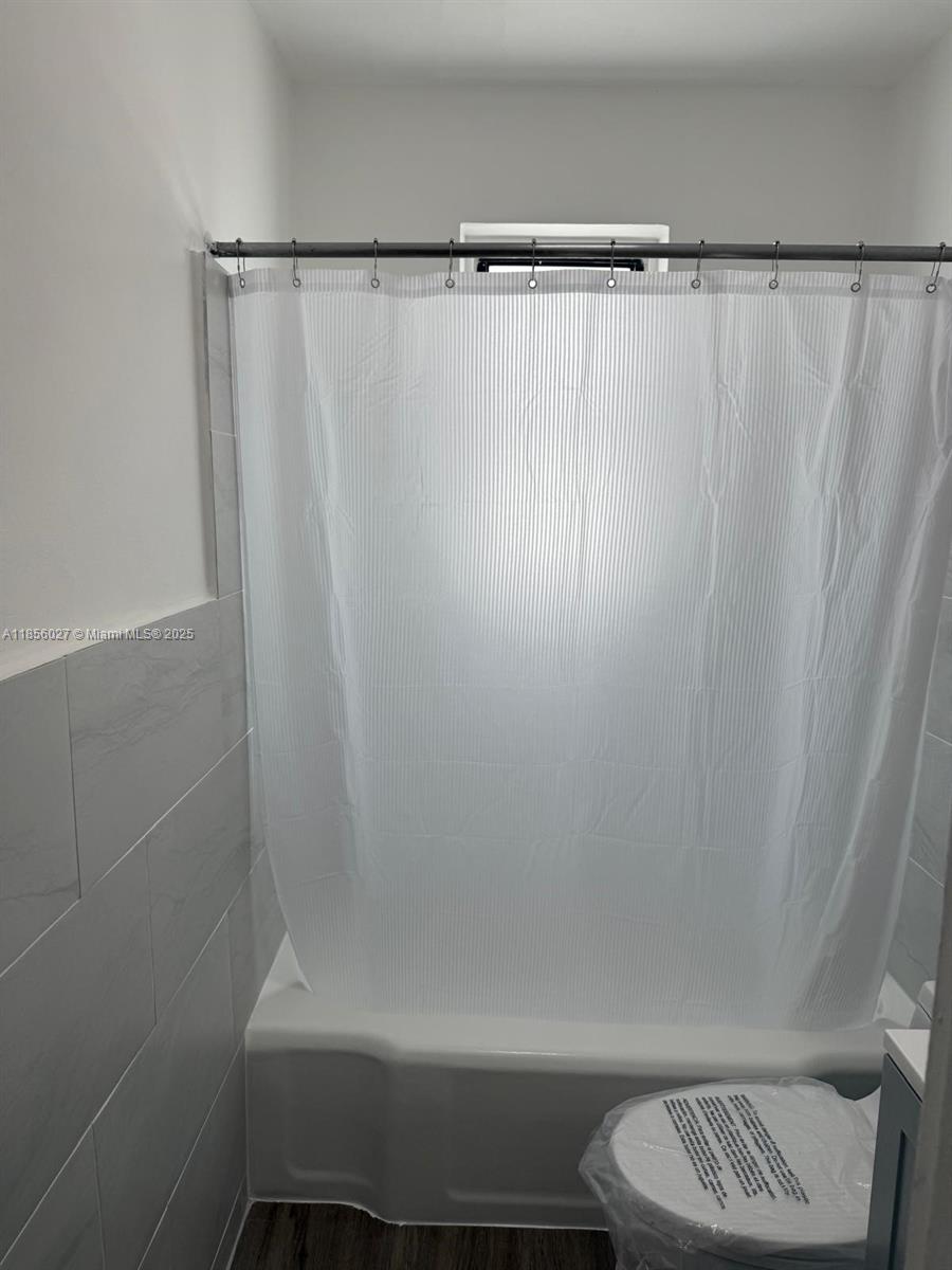 1432 Northeast 163rd Street, Unit 2 North Miami Beach, FL 33162 - Photo 17 of 18 a bathroom with a shower and a toilet