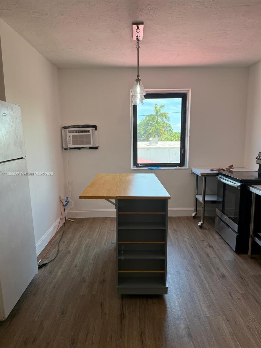 1432 Northeast 163rd Street, Unit 2 North Miami Beach, FL 33162 - Photo 2 of 18 a room with wooden floor and window