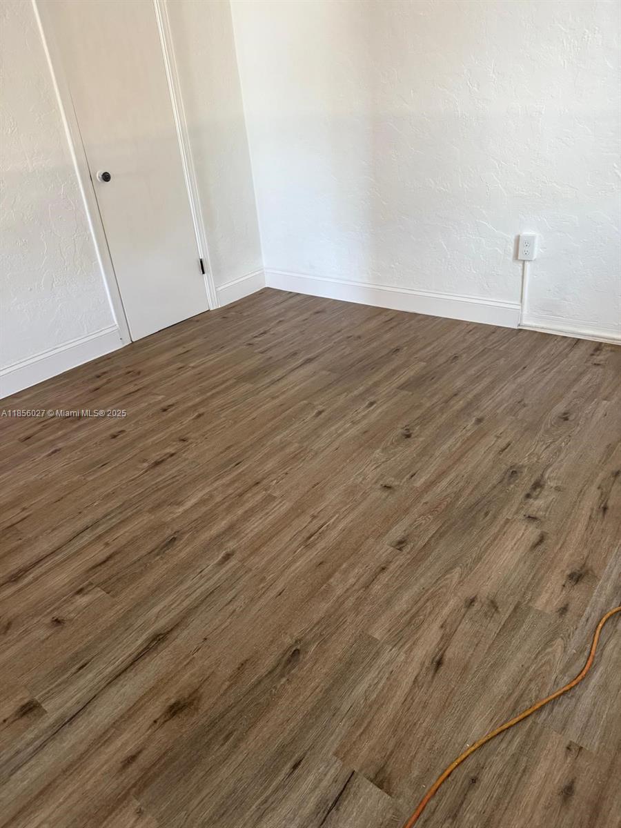 1432 Northeast 163rd Street, Unit 2 North Miami Beach, FL 33162 - Photo 5 of 18 a view of empty room with wooden floor