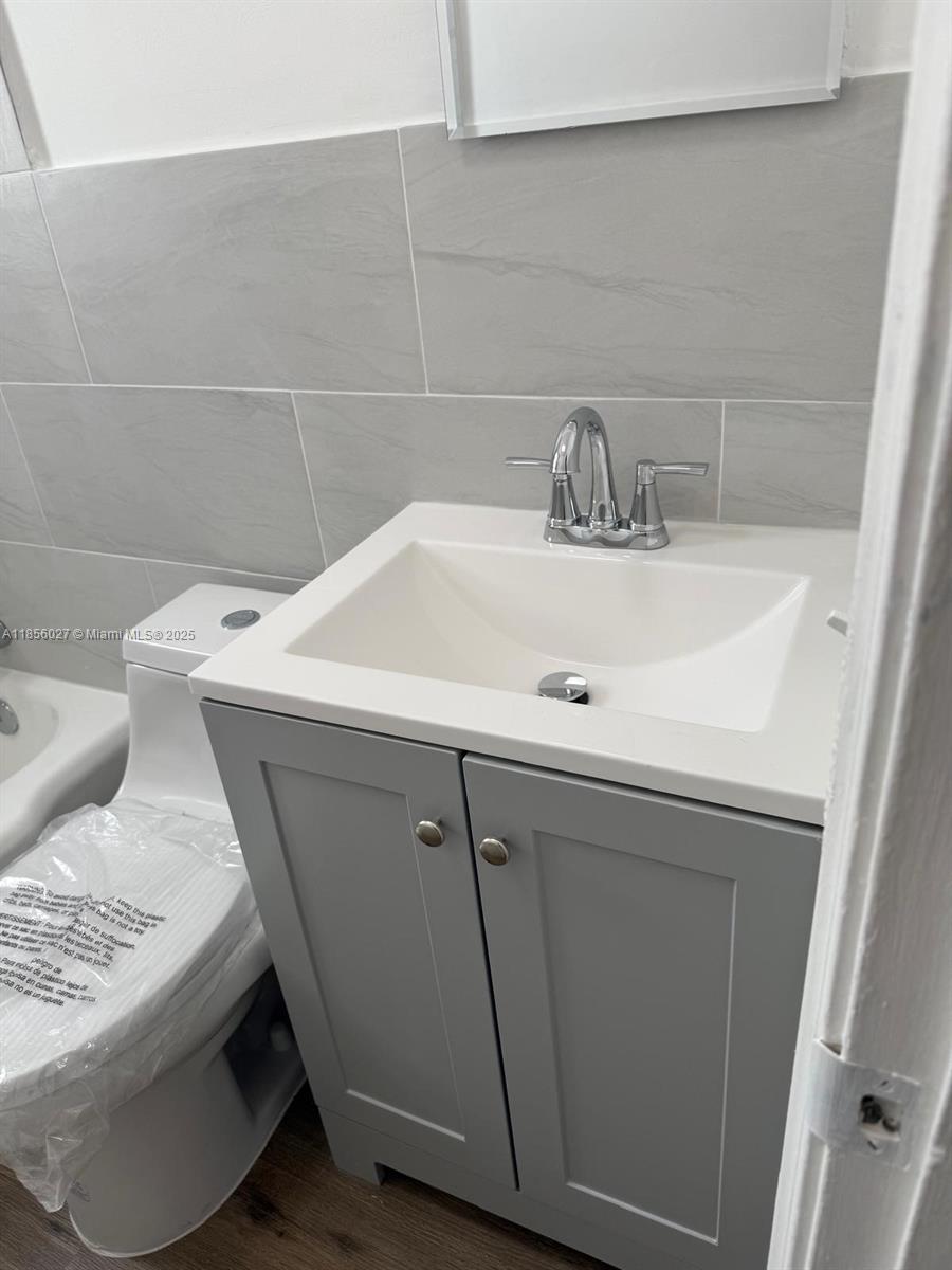 1432 Northeast 163rd Street, Unit 2 North Miami Beach, FL 33162 - Photo 9 of 18 a bathroom with a sink and a toilet