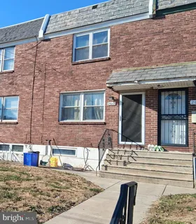a view of a brick house with many windows