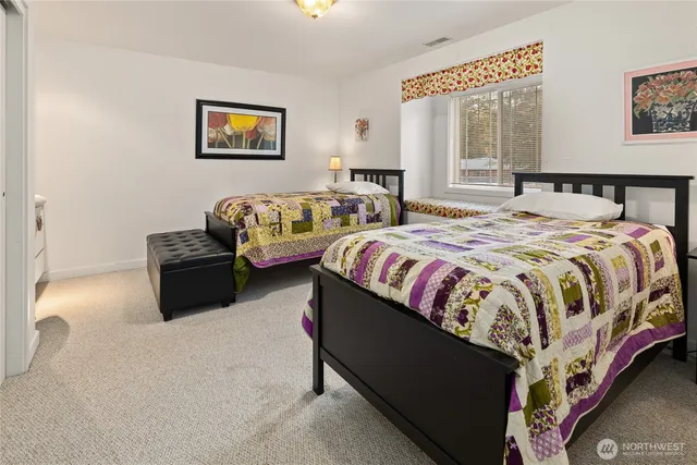 a spacious bedroom with a bed and window