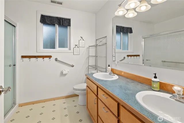 a bathroom with a sink a toilet and a mirror