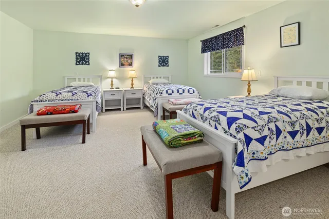 a bedroom with two beds and a desk