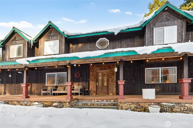 a front view of a house with a garden and parking
