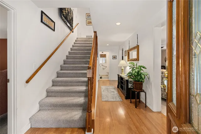 a view of entryway and hall with wooden floor