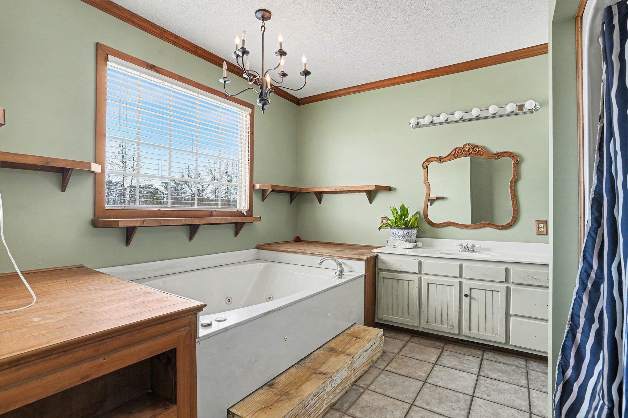 202 Highway 747 Loris Sc 29569 Loris, SC 29569 - Photo 17 of 34 Full bathroom with vanity, a whirlpool tub, crown molding, a textured ceiling, and a chandelier, and shower