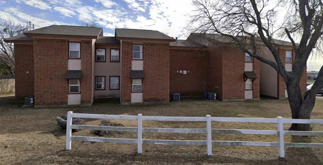 a front view of a house with a garden and plants