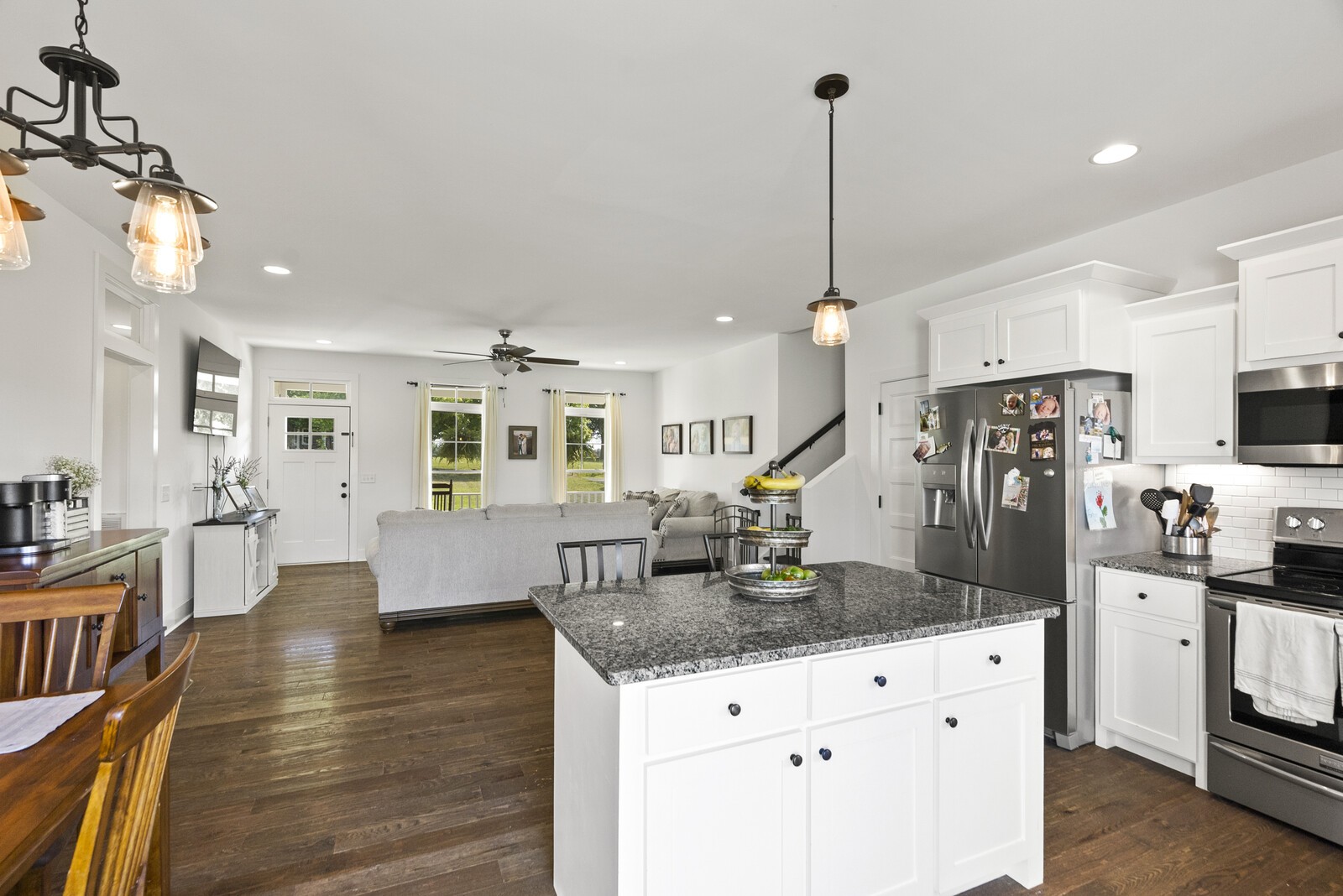 6014 Brown Road Springfield, TN 37172 - Photo 7 of 15 a kitchen with stainless steel appliances kitchen island granite countertop a refrigerator a sink dishwasher a dining table and chairs with wooden floor