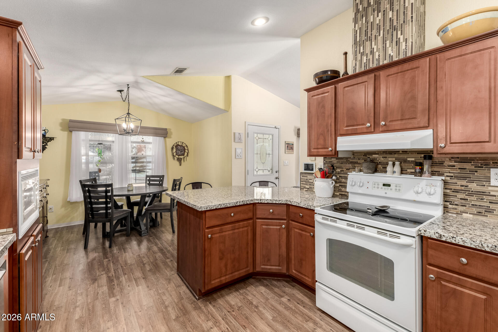 201 South Greenfield Road, Unit 124 Mesa, AZ 85206 - Photo 12 of 31 a kitchen with a sink stove cabinets and wooden floor