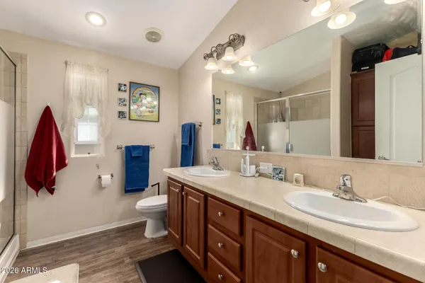 a spacious bathroom with a double vanity sink and a mirror