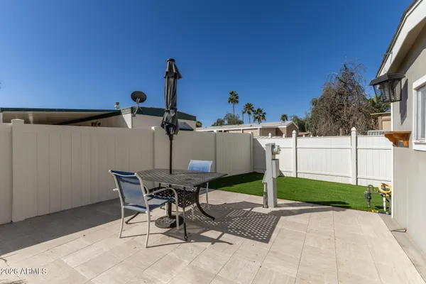 a view of a patio with table and chairs