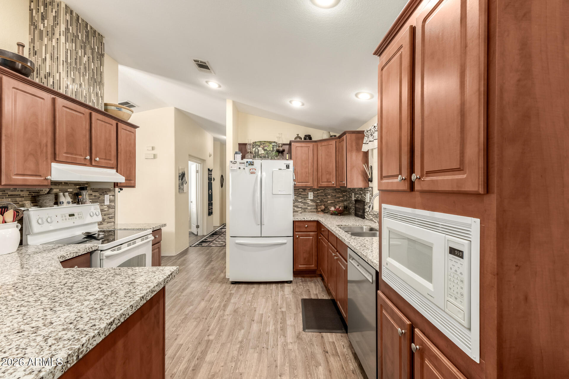 201 South Greenfield Road, Unit 124 Mesa, AZ 85206 - Photo 9 of 31 a kitchen with stainless steel appliances granite countertop a stove refrigerator sink and cabinets
