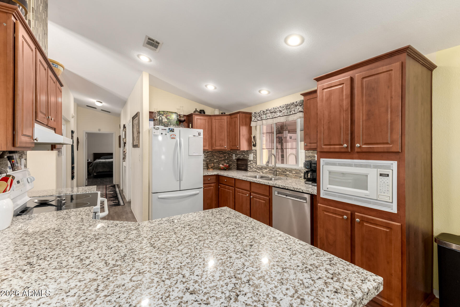 201 South Greenfield Road, Unit 124 Mesa, AZ 85206 - Photo 10 of 31 a kitchen with stainless steel appliances granite countertop a refrigerator stove and sink