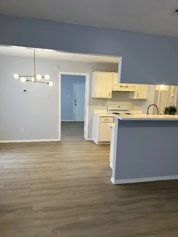 a kitchen with stainless steel appliances granite countertop a sink a stove top oven a counter space and cabinets