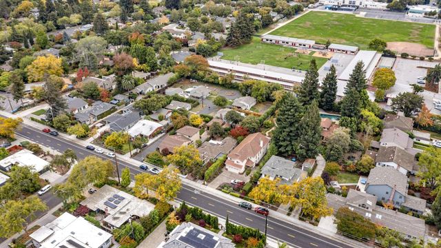 an aerial view of a residential houses with outdoor space