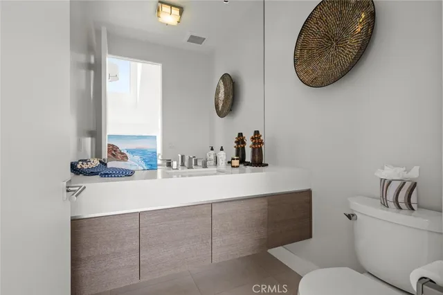 a bathroom with a sink toilet and mirror