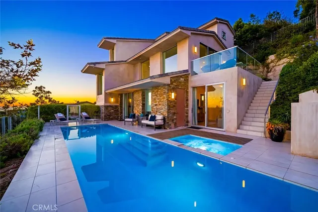 a view of an outside dining space with furniture and city view