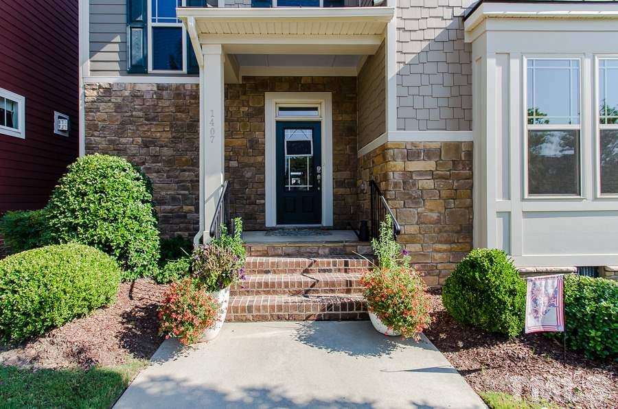 1407 Van Page Boulevard Raleigh, NC 27607 - Photo 2 of 25 a front view of a house with a garden