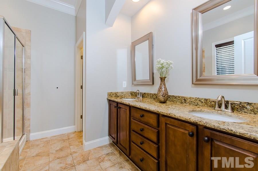 1407 Van Page Boulevard Raleigh, NC 27607 - Photo 14 of 25 a bathroom with a granite countertop sink and a mirror