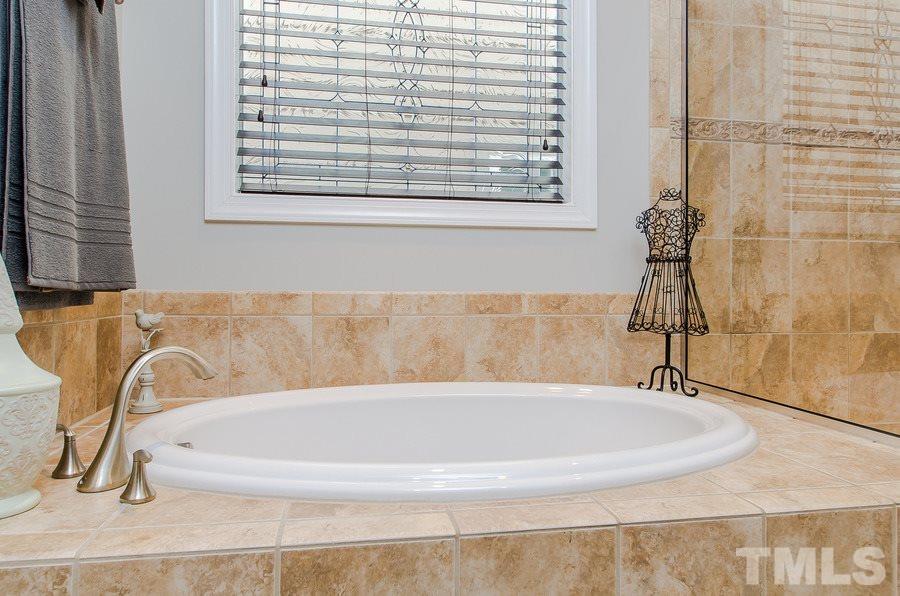 1407 Van Page Boulevard Raleigh, NC 27607 - Photo 15 of 25 a bath tub sitting next to a window