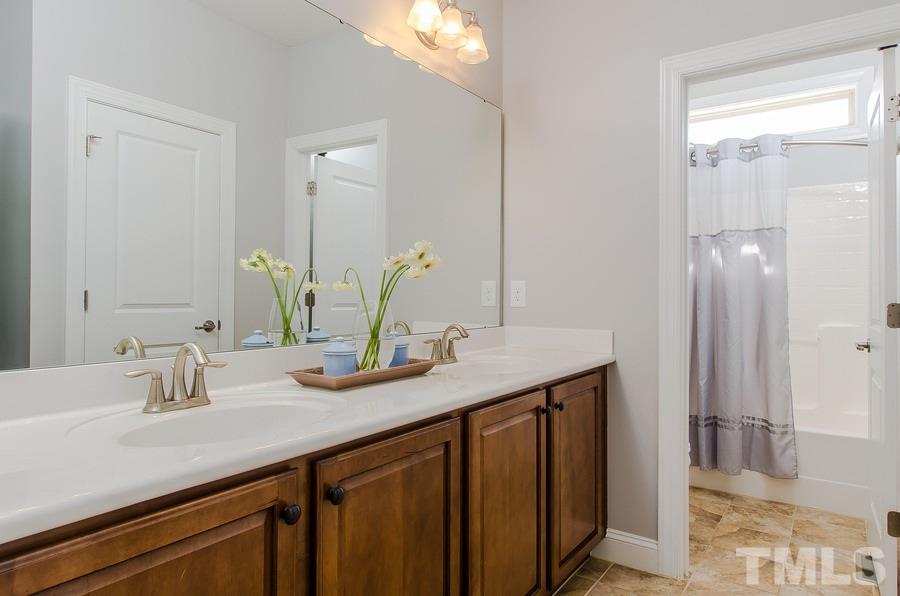 1407 Van Page Boulevard Raleigh, NC 27607 - Photo 18 of 25 a bathroom with a sink and a mirror