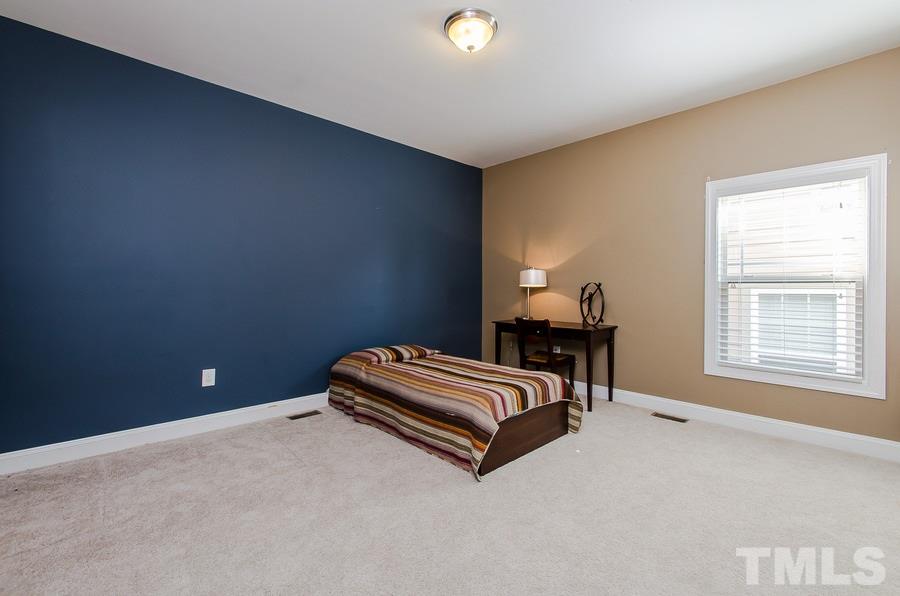 1407 Van Page Boulevard Raleigh, NC 27607 - Photo 19 of 25 a room with a bed and a window