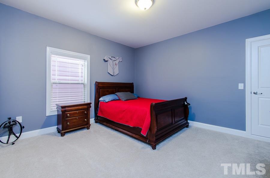 1407 Van Page Boulevard Raleigh, NC 27607 - Photo 20 of 25 a room with a bed and a chair